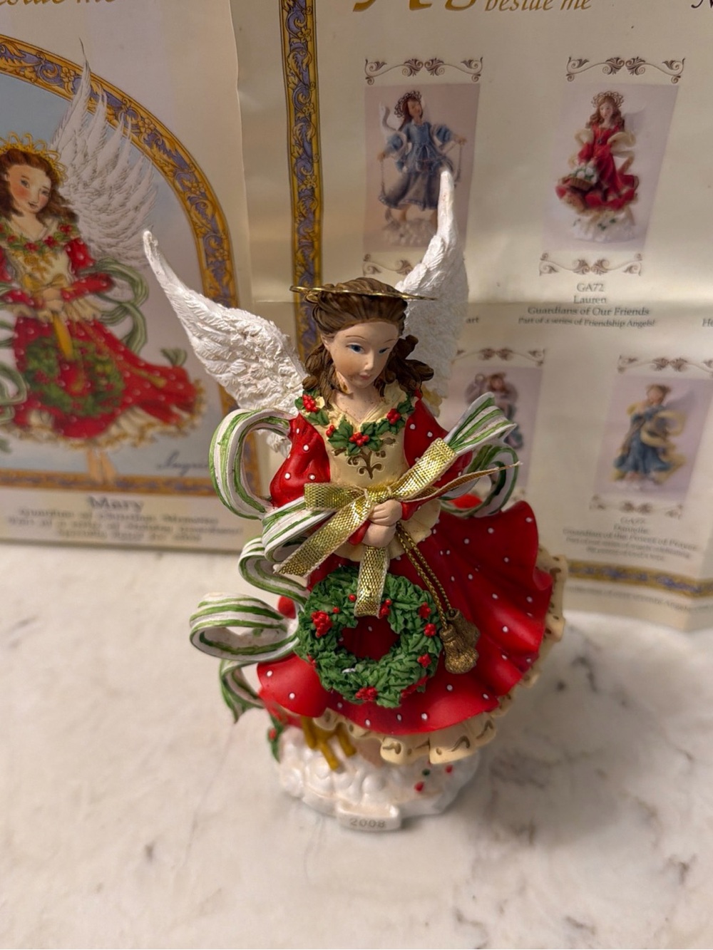 Festive Red Angel Figurine with Wreath and Gold Ribbon